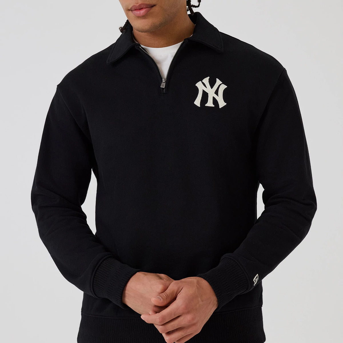 The model is wearing this MLB New York Yankees 1/4 Zip Sweater in black. 3