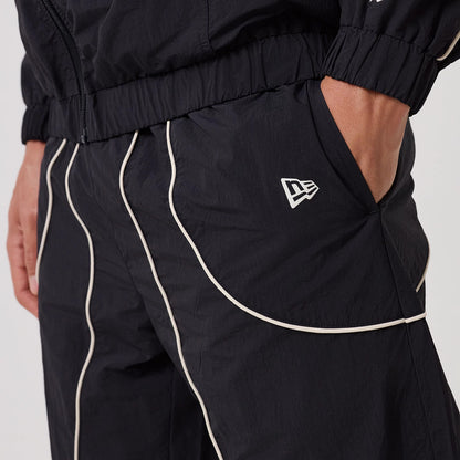 The model is wearing this MLB Piping New York Yankees Track Pants in navy. 4
