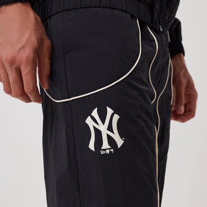 The model is wearing this MLB Piping New York Yankees Track Pants in navy. 3