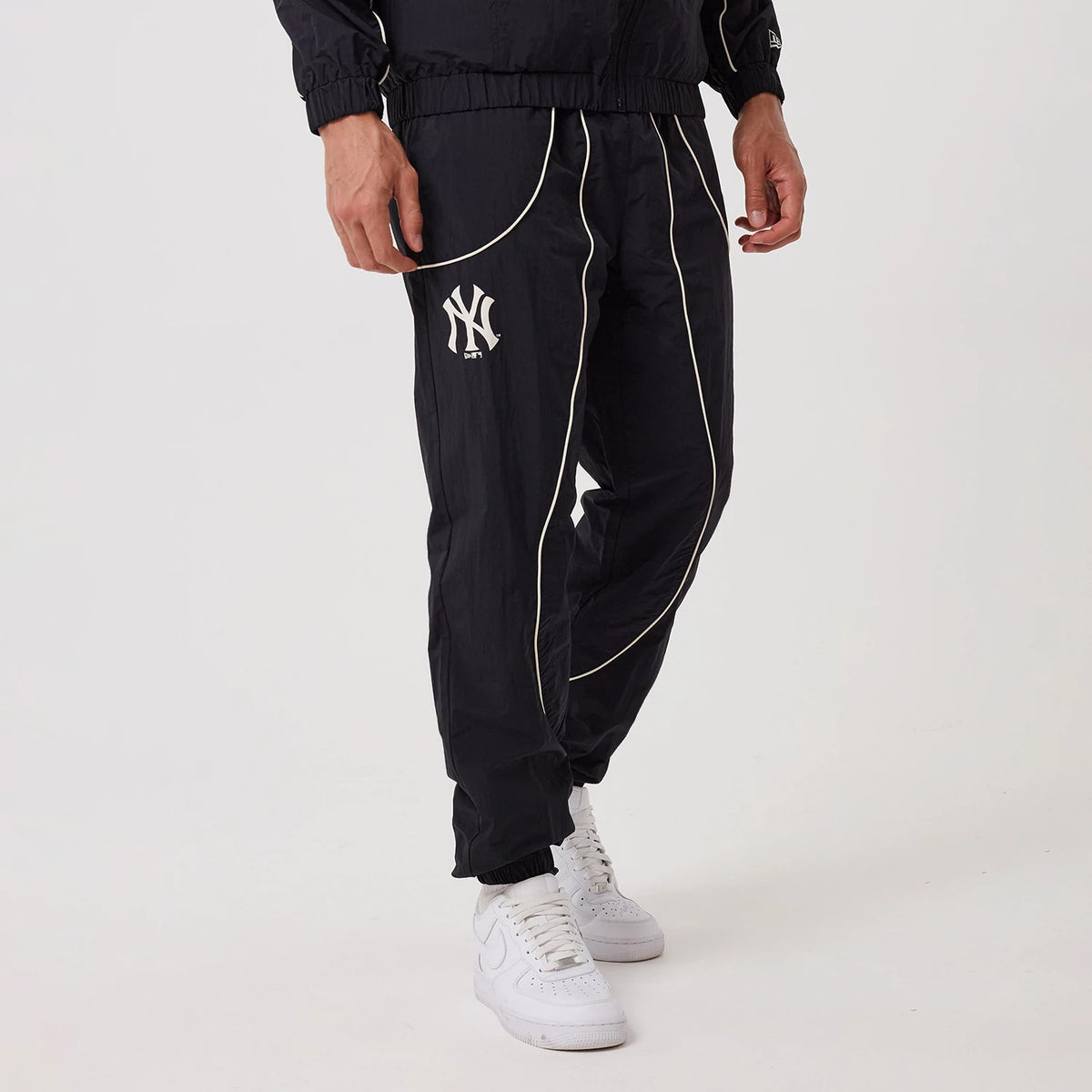 The model is wearing this MLB Piping New York Yankees Track Pants in navy. 1