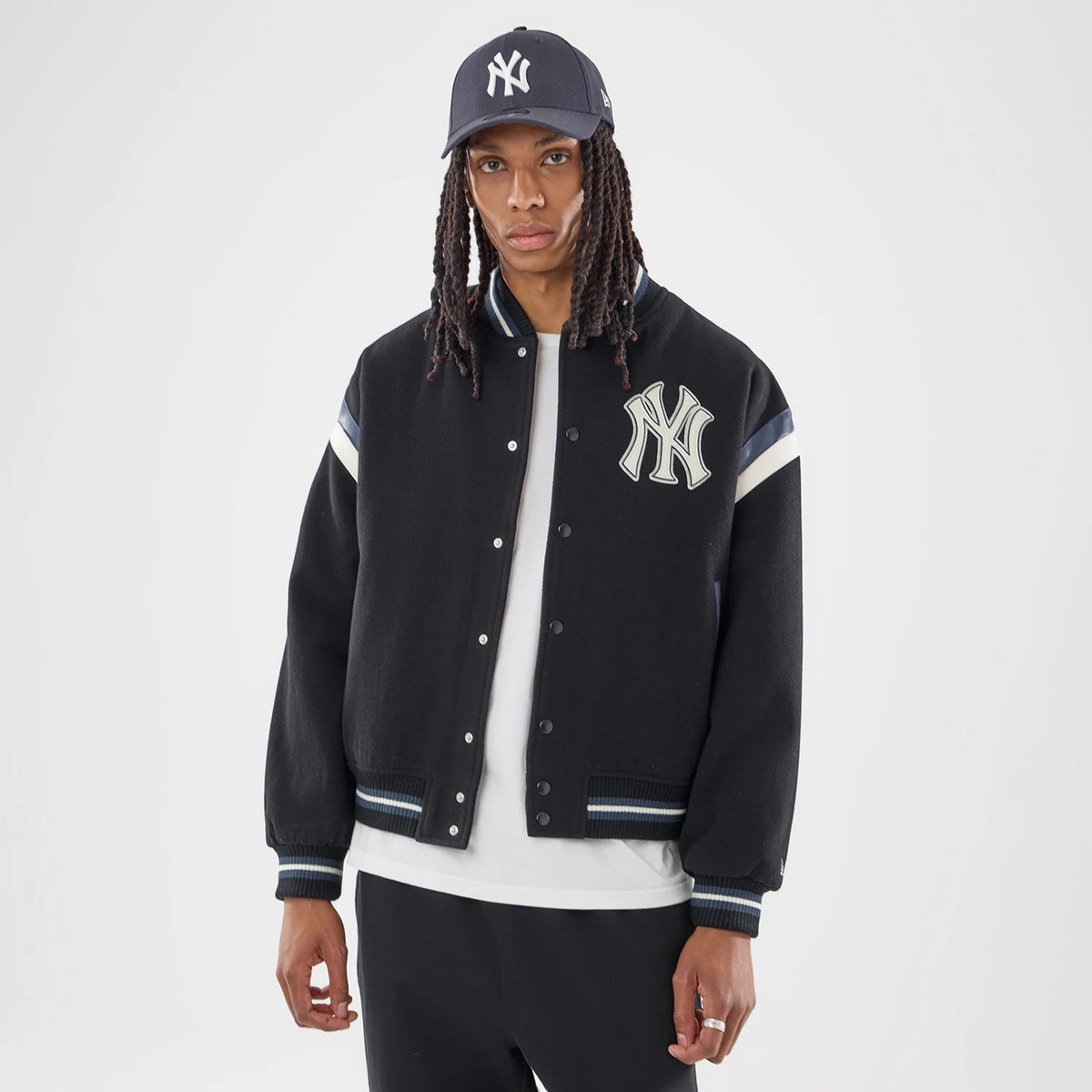 The model is wearing this MLB New York Yankees Varsity Jacket in black. 2