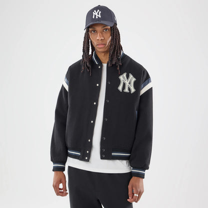 The model is wearing this MLB New York Yankees Varsity Jacket in black. 2