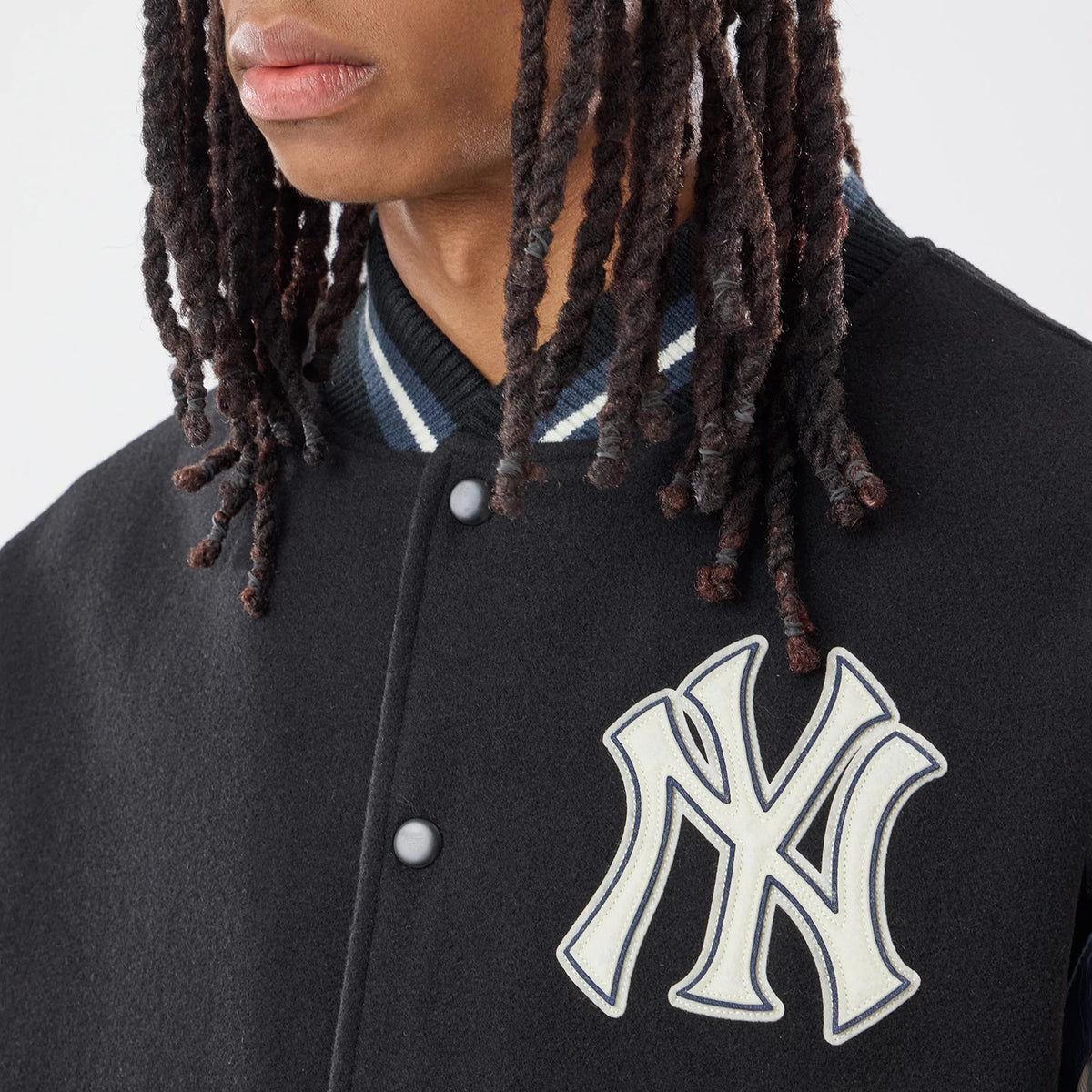 The model is wearing this MLB New York Yankees Varsity Jacket in black. 3