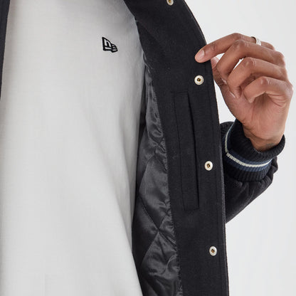 The model is wearing this MLB New York Yankees Varsity Jacket in black. 5