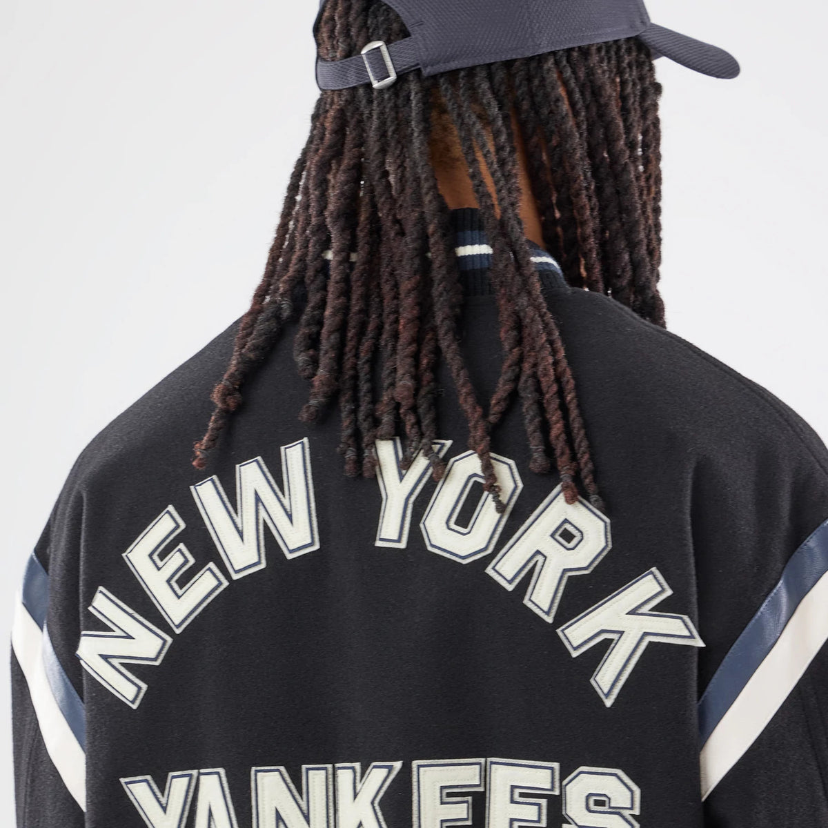 The model is wearing this MLB New York Yankees Varsity Jacket in black. 6