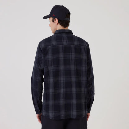 New Era New York Yankees MLB Plaid Navy Long Sleeve Shirt, back view on a model with a navy cap, showing the navy and grey checkered pattern, structured collar, and buttoned cuffs on the long sleeves, creating a classic casual look.