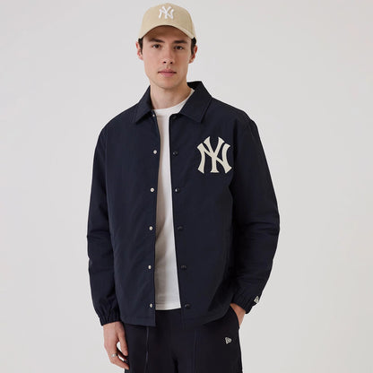 The model is wearing this MLB New York Yankees Coach Jacket in navy. 1