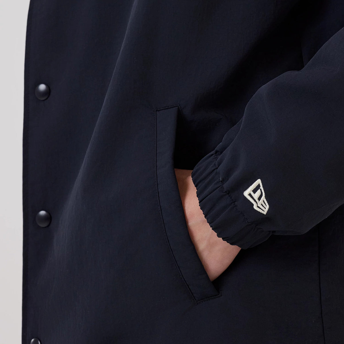 The model is wearing this MLB New York Yankees Coach Jacket in navy. 6