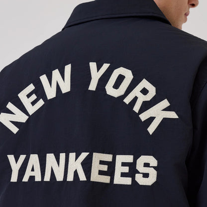 The model is wearing this MLB New York Yankees Coach Jacket in navy. 4