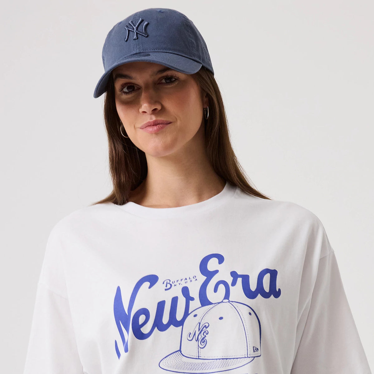 The model is wearing this New Era Heritage Oversized T-Shirt in white. 6