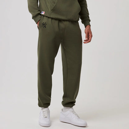 The model is wearing this MLB League Essential New York Yankees Joggers in green. 1