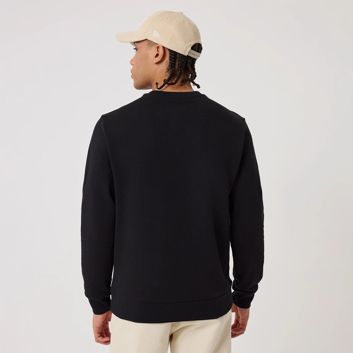 The model is wearing this MLB Linear New York Yankees Crew Neck Sweater in black. 2