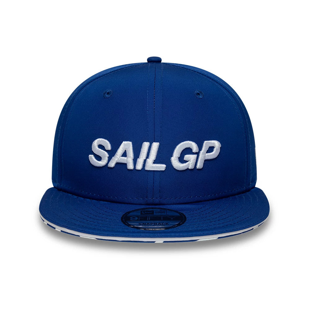 Sail GP Limited Blue New Era 9FIFTY Snapback Adjustable Cap, front view showing white embroidered SAIL GP lettering on the structured blue crown, a flat blue visor with a 9FIFTY size sticker, and two eyelets on each side.