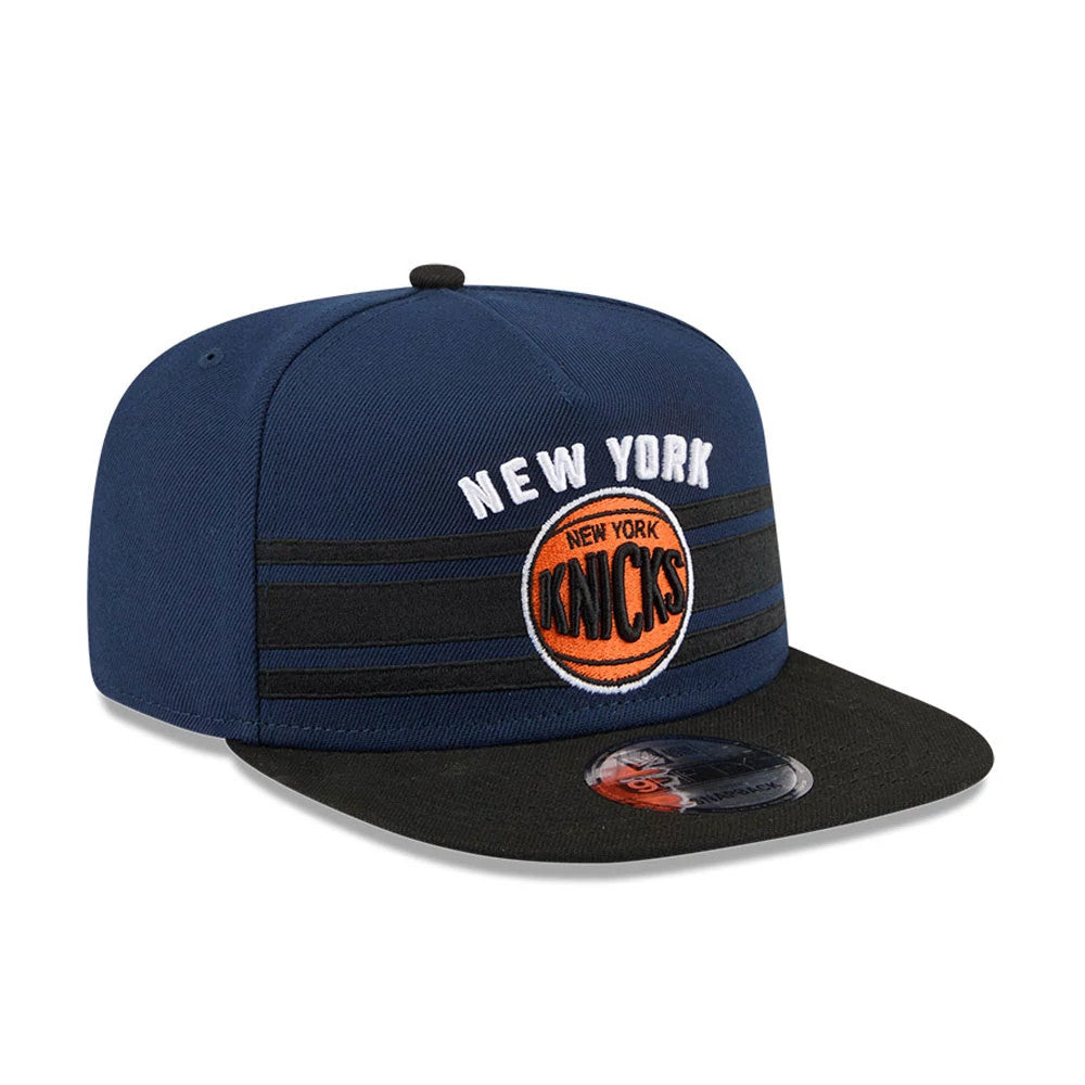 New York Knicks NBA Tip Off 2026 Dark Blue New Era 9FIFTY A-Frame Snapback Adjustable Cap, front view showing the white embroidered New York arch and orange Knicks logo on the dark blue front panel, with a flat black visor and a 9FIFTY size sticker.