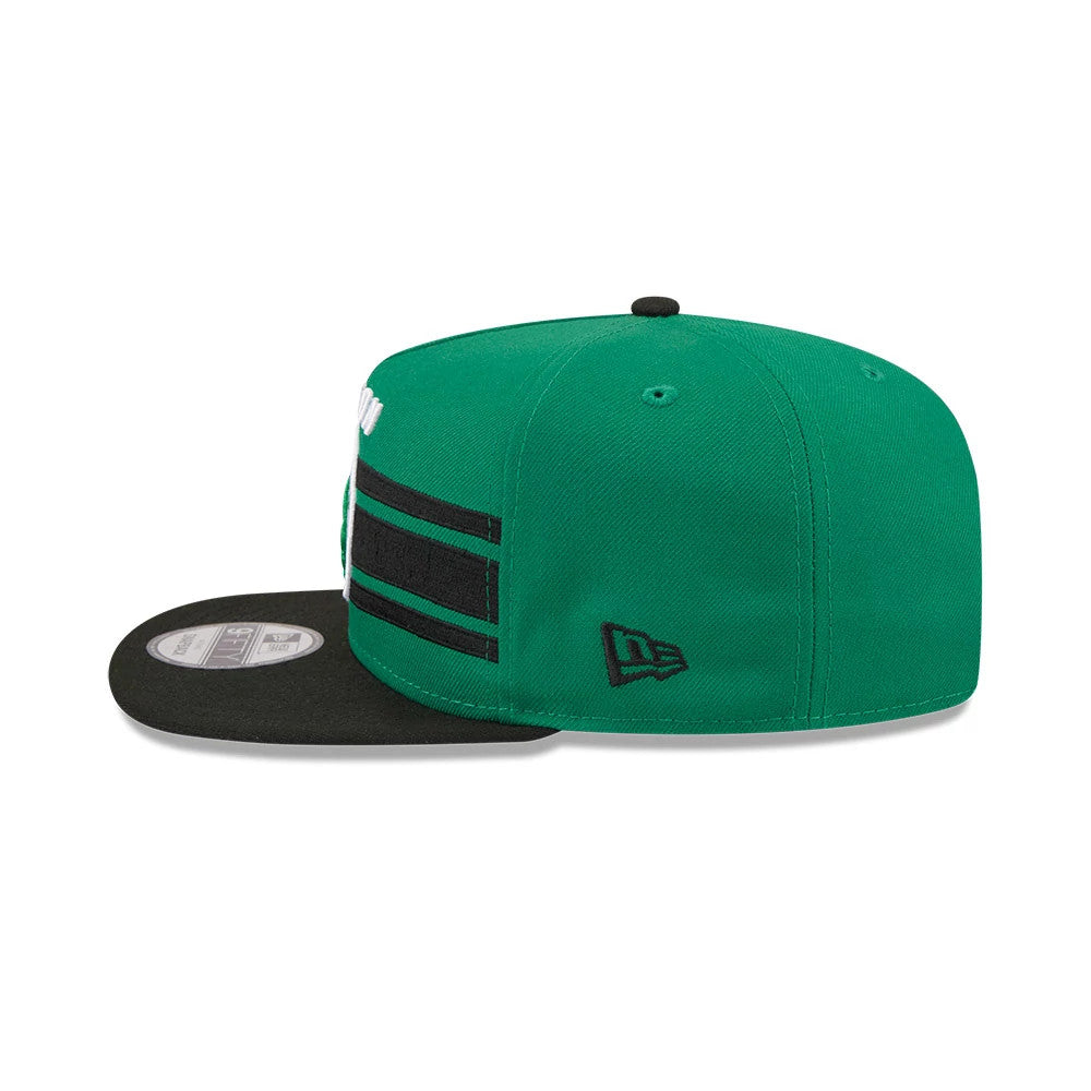 Boston Celtics NBA Tip Off 2026 Green New Era 9FIFTY A-Frame Snapback Adjustable Cap, side view showing the black New Era flag logo embroidered on the left side, with a black flat visor and double horizontal stripe detail on the green crown.