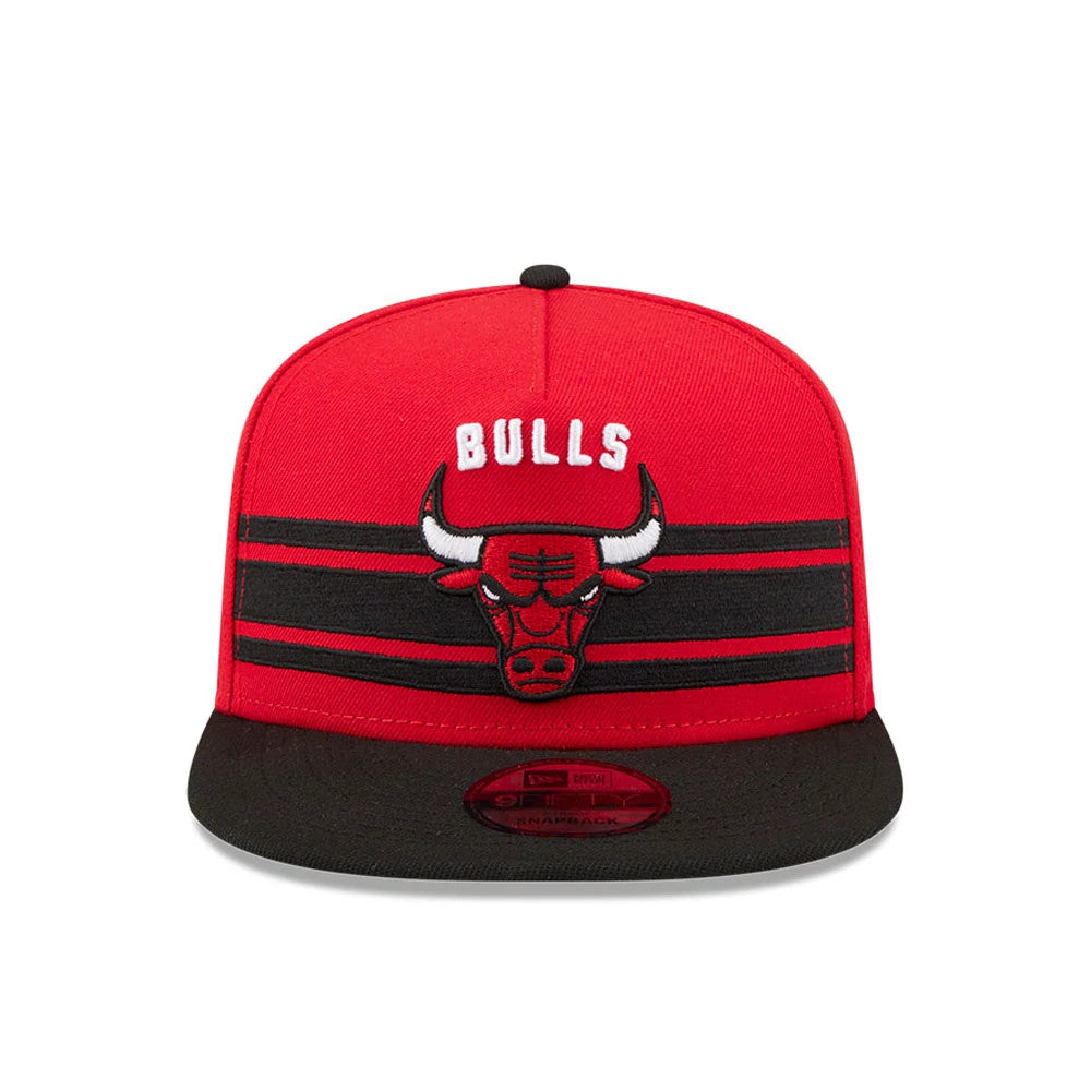 Chicago Bulls NBA Tip Off 2026 Red New Era 9FIFTY A-Frame Snapback Adjustable Cap, front view showing the raised embroidered Bulls logo with BULLS above it, black two-stripe on the red crown, and a black flat visor with a 9FIFTY size sticker.