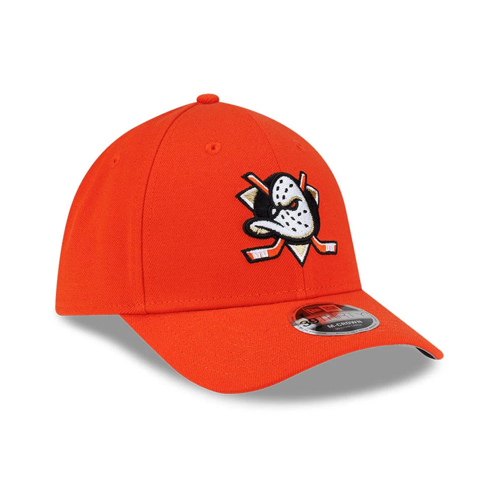 Anaheim Ducks NHL Team Orange New Era 39THIRTY M-Crown Stretch Fit Cap, three-quarter view showing the dark orange embroidered duck logo on the front panel, a matching orange curved visor, and a 39THIRTY size sticker on the upper side of the visor.