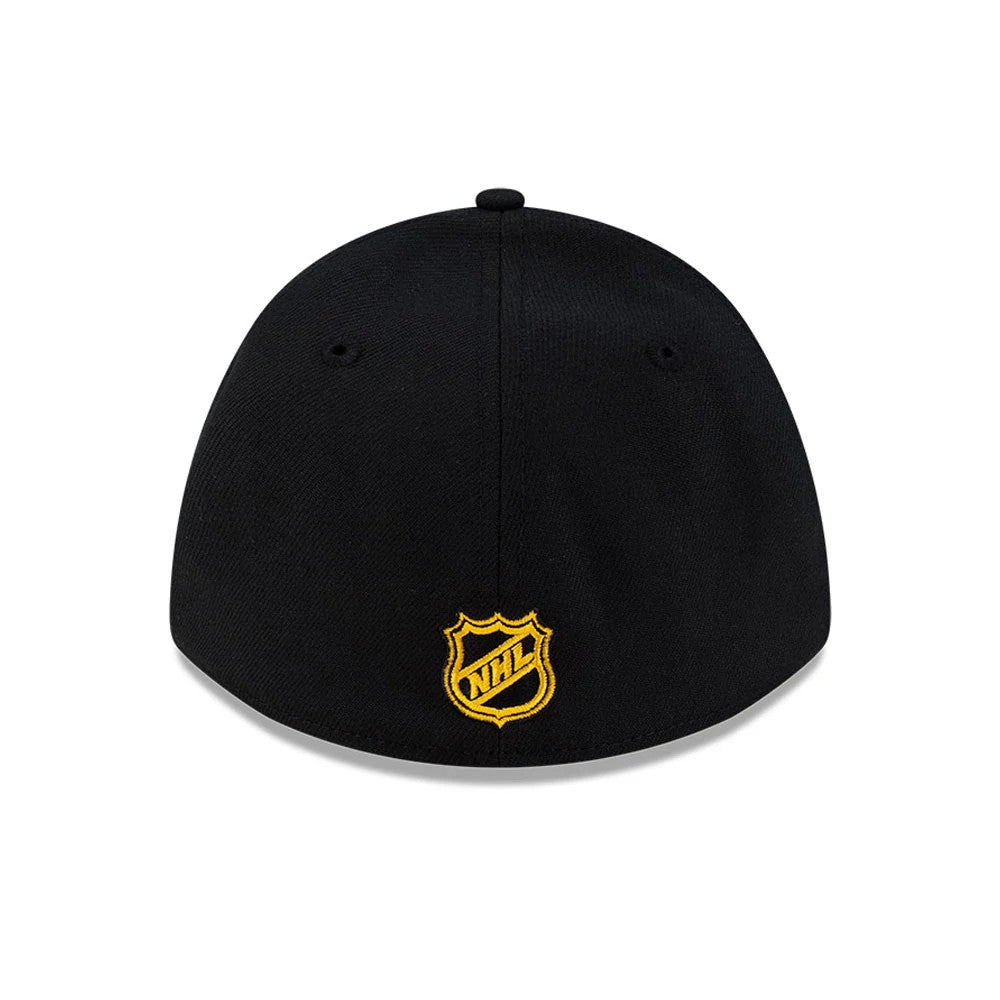 Boston Bruins NHL Team Black New Era 39THIRTY M-Crown Stretch Fit Cap, rear view showing the gold embroidered NHL shield logo centred on the back panel, with black eyelets and a rounded black crown.