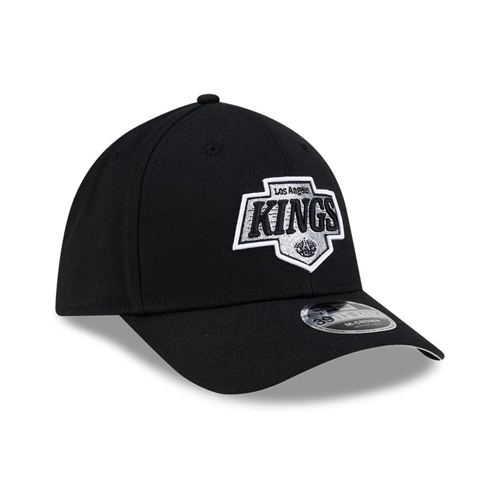 LA Kings NHL Team Black New Era 39THIRTY M-Crown Stretch Fit Cap, three-quarter view showing the raised white and silver embroidered LA Kings logo on the front panel, with a black curved visor and a 39THIRTY size sticker on top.