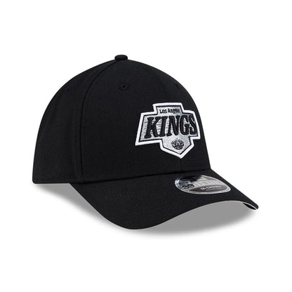 LA Kings NHL Team Black New Era 39THIRTY M-Crown Stretch Fit Cap, three-quarter view showing the raised white and silver embroidered LA Kings logo on the front panel, with a black curved visor and a 39THIRTY size sticker on top.