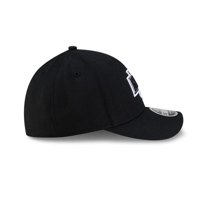LA Kings NHL Team Black New Era 39THIRTY M-Crown Stretch Fit Cap, side view showing the raised black and white LA Kings logo embroidered on the front panel, curved black visor, and the structured shape of the black crown.