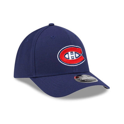 Montreal Canadiens NHL Team Navy New Era 39THIRTY M-Crown Stretch Fit Cap, three-quarter view showing the raised red and white embroidered Canadiens logo on the front panel, blue curved visor with 39THIRTY size sticker, and matching blue eyelets.