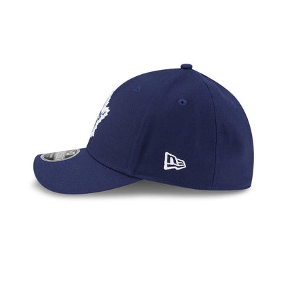 Toronto Maple Leafs NHL Team Navy New Era 39THIRTY M-Crown Stretch Fit Cap, side view showing the white embroidered New Era flag logo on the left side, the curved navy visor with an MLB size sticker, and matching navy eyelets.