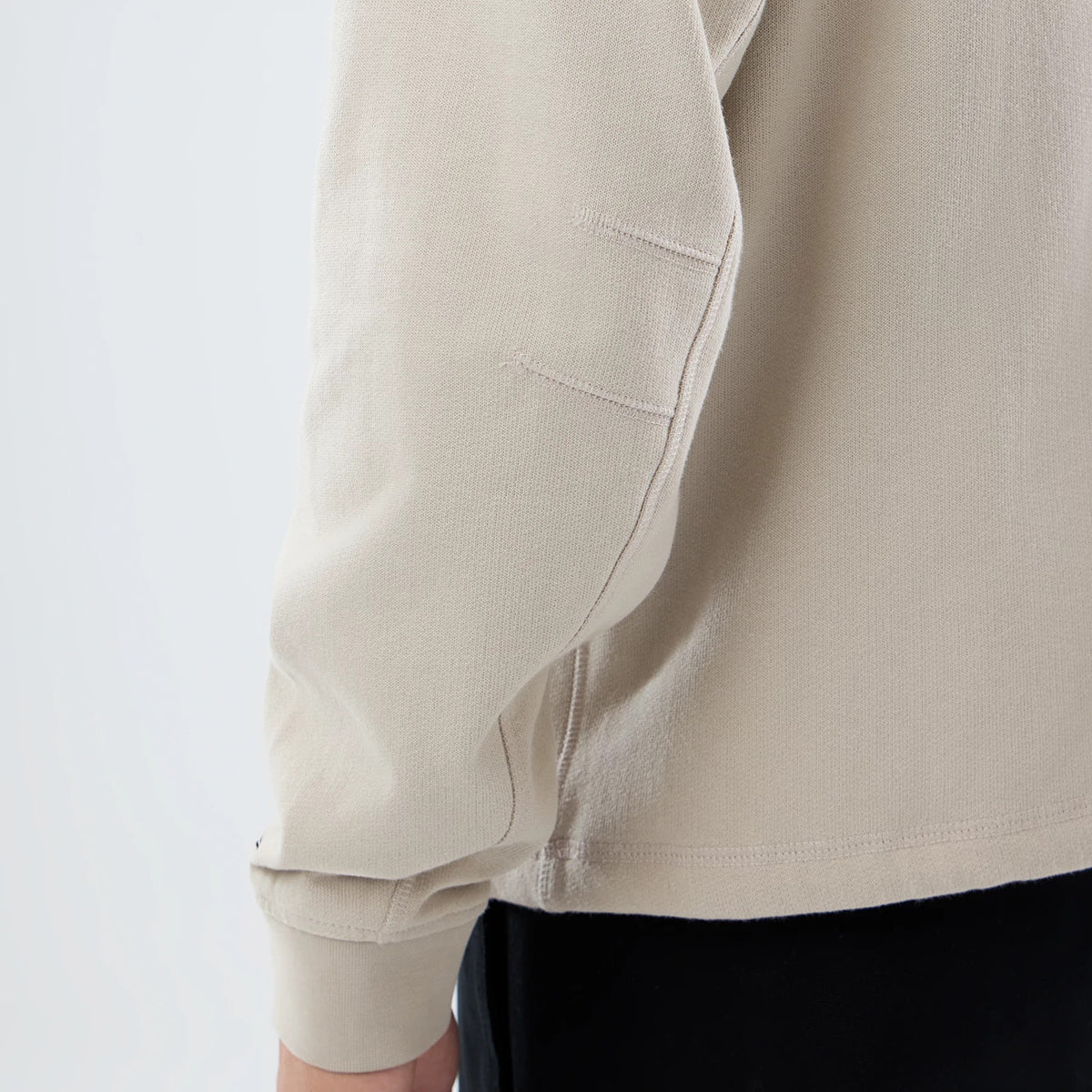 The model is wearing this New Era Open Hem Pullover Hoodie in light beige. 6