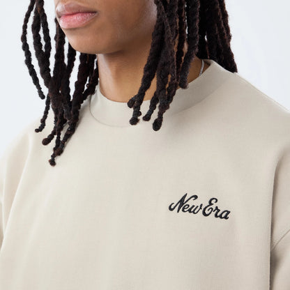 The model is wearing this New Era Open Hem Oversized Crew Neck Sweater in light beige. 4
