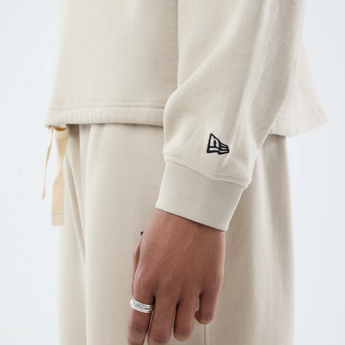 The model is wearing this New Era Open Hem Oversized Crew Neck Sweater in light beige. 6