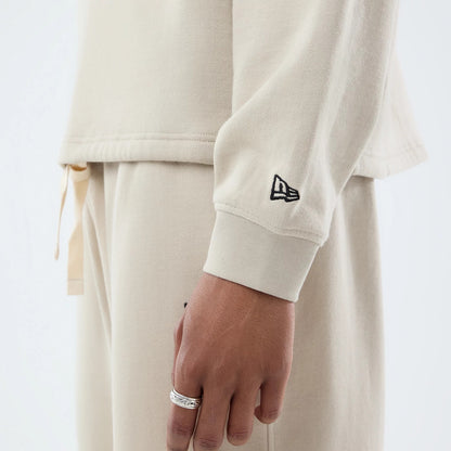 The model is wearing this New Era Open Hem Oversized Crew Neck Sweater in light beige. 6