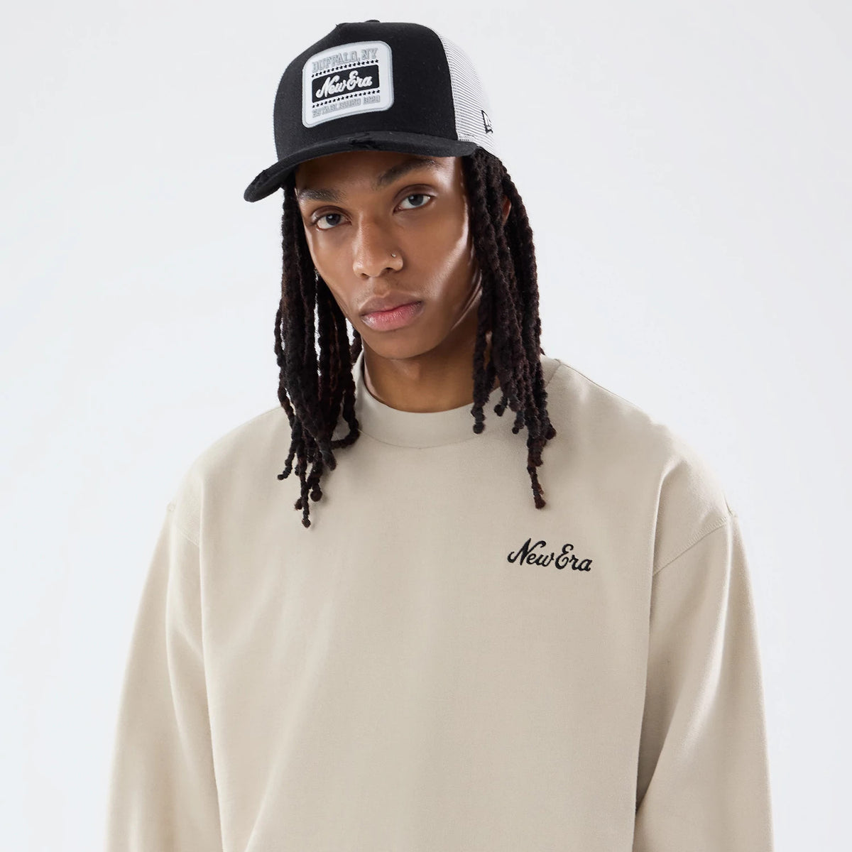 The model is wearing this New Era Open Hem Oversized Crew Neck Sweater in light beige. 7