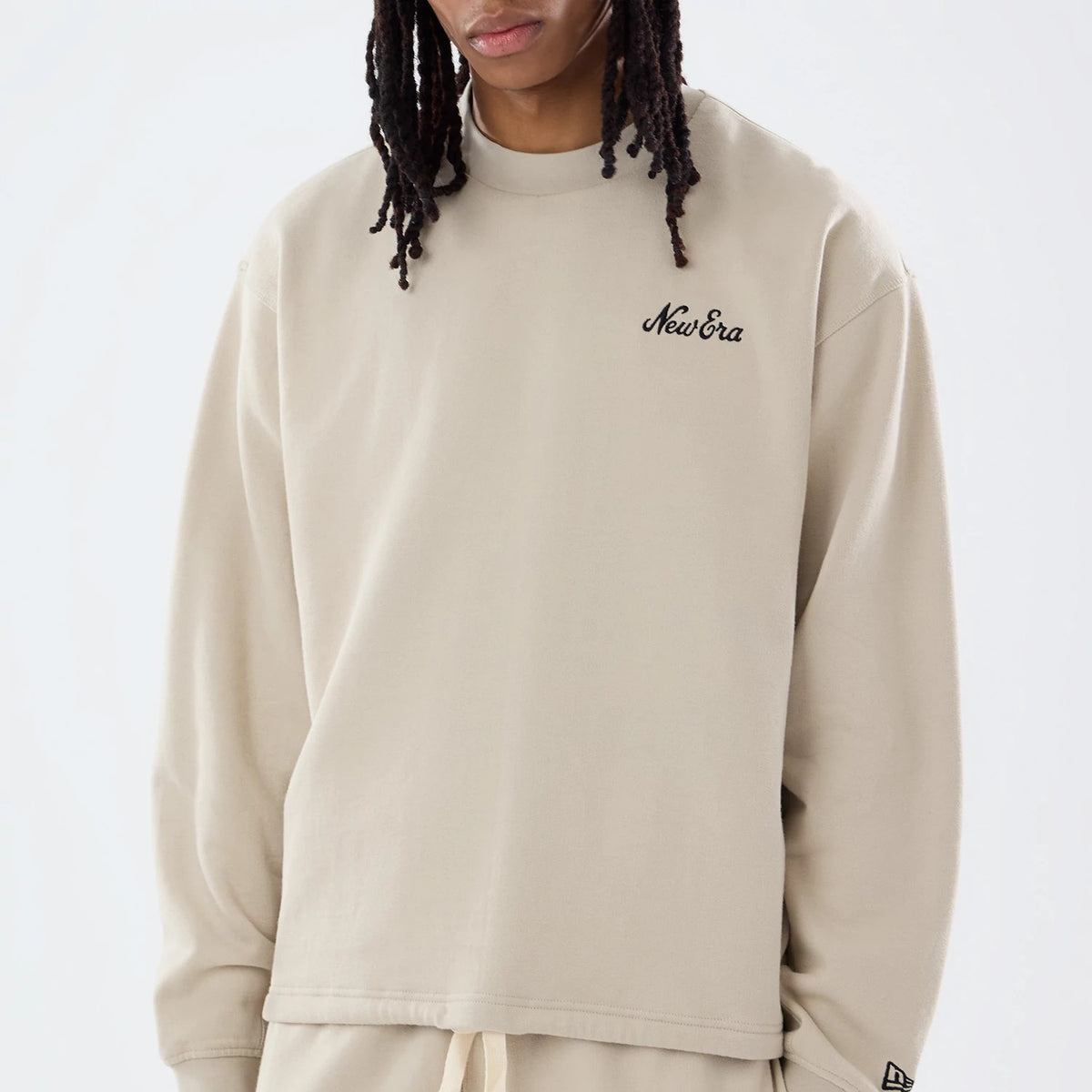 The model is wearing this New Era Open Hem Oversized Crew Neck Sweater in light beige. 3