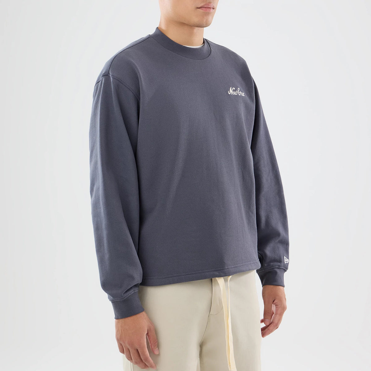 The model is wearing this New Era Open Hem Oversized Crew Neck Sweater in dark grey. 7