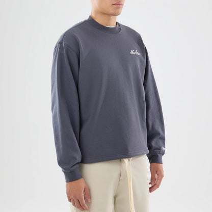 The model is wearing this New Era Open Hem Oversized Crew Neck Sweater in dark grey. 7
