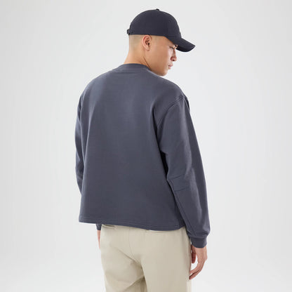 The model is wearing this New Era Open Hem Oversized Crew Neck Sweater in dark grey. 2