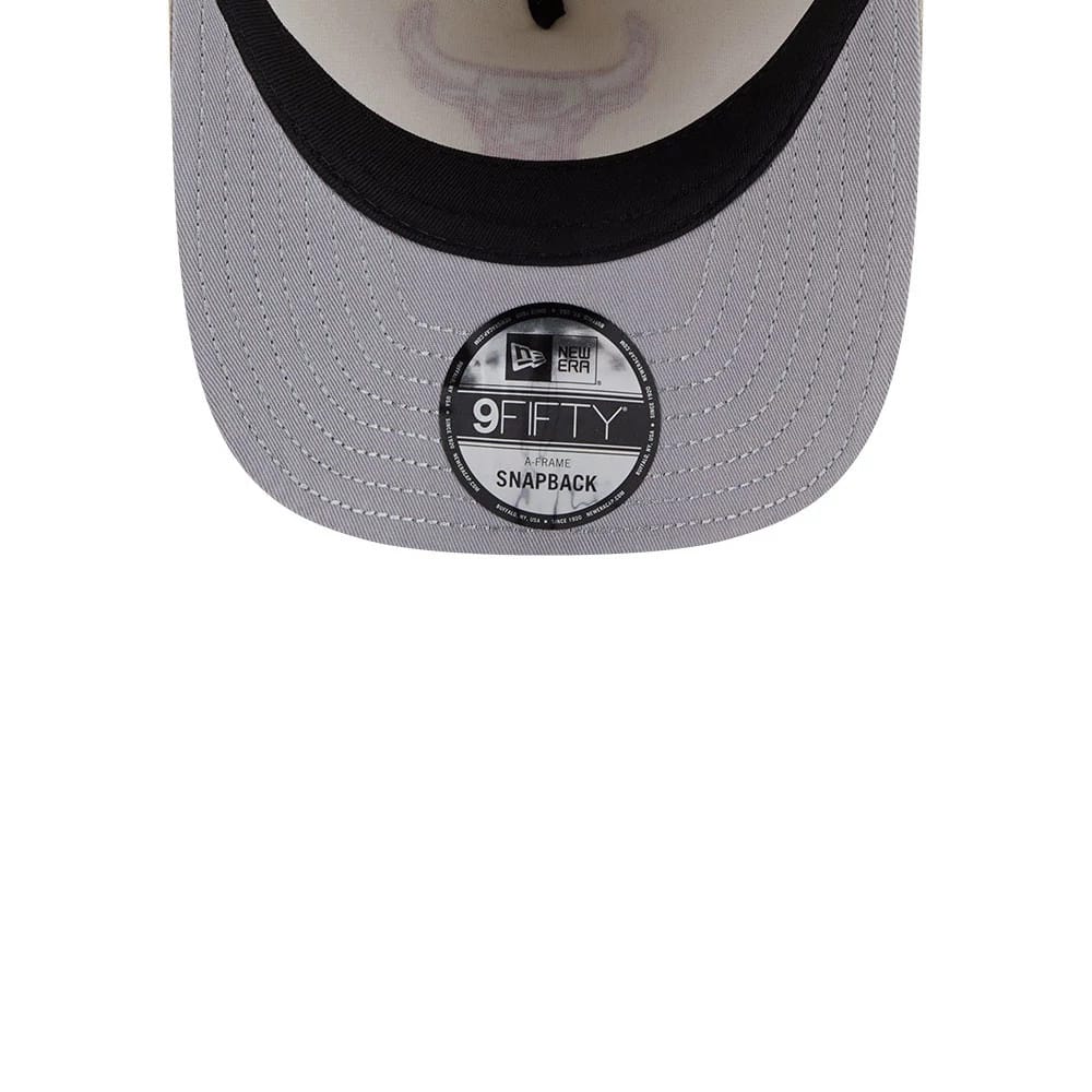 Chicago Bulls NBA Light Beige New Era 9FIFTY A-Frame Snapback Adjustable Cap, inside view showing the black 9FIFTY size sticker on the grey visor, with the faint outline of the Bulls logo on the light beige undervisor.