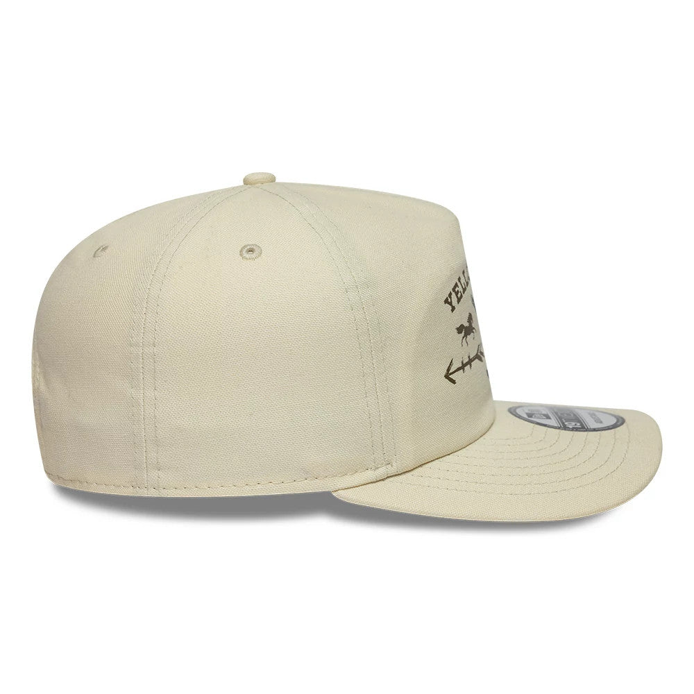Paramount Yellowstone Light Beige New Era 19TWENTY Adjustable Cap, side view showing a flat visor with a round 19TWENTY size sticker, a transcribed design featuring Yellowstone and an arrow motif on the front panel.