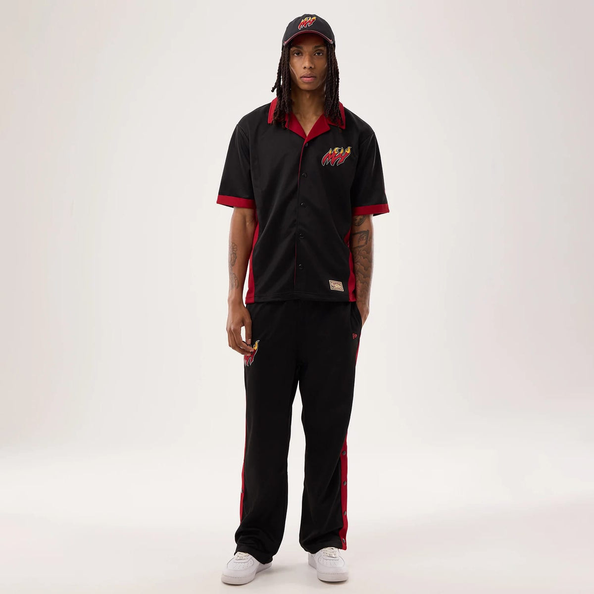 The model is wearing this NBA Hardwood Classic Revere Miami Heat Short Sleeve Shirt in black. 8