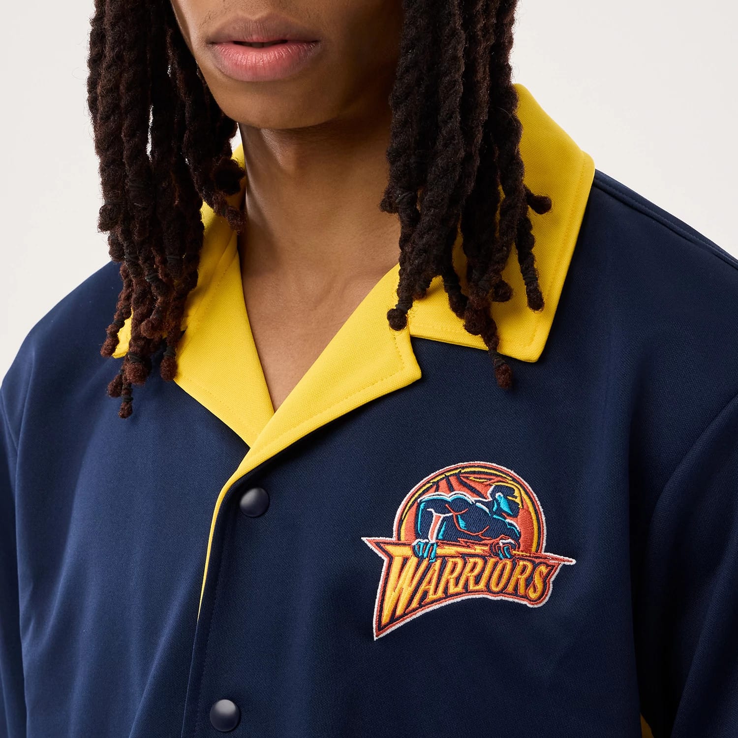 The model is wearing this NBA Hardwood Classic Revere Golden State Warriors Short Sleeve Shirt in dark blue. 6