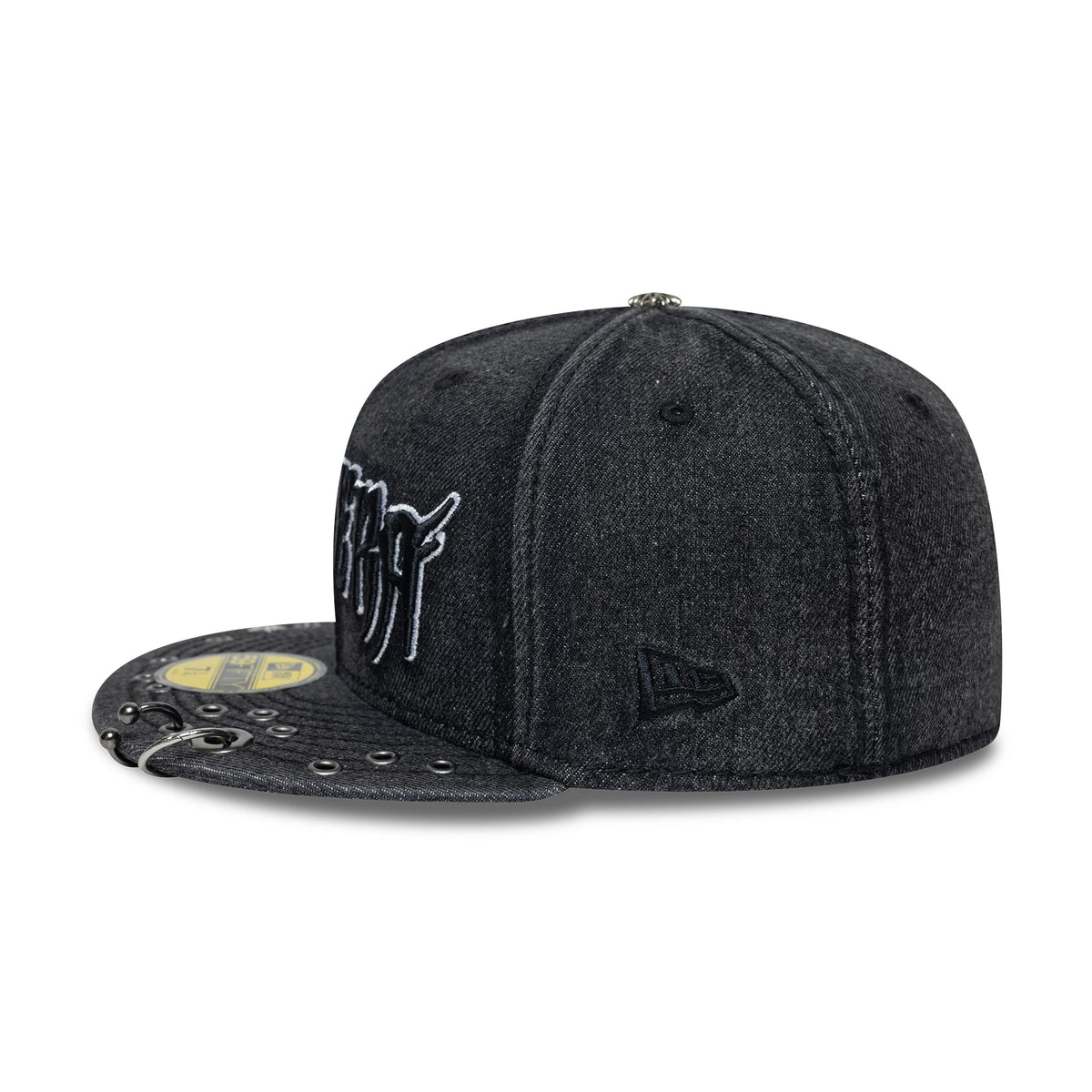 New Era Hardware Washed Black 59FIFTY Fitted Cap, side view showing the black embroidered New Era flag logo on the left side, a textured black visor with silver eyelet details, and a gold 59FIFTY size sticker.