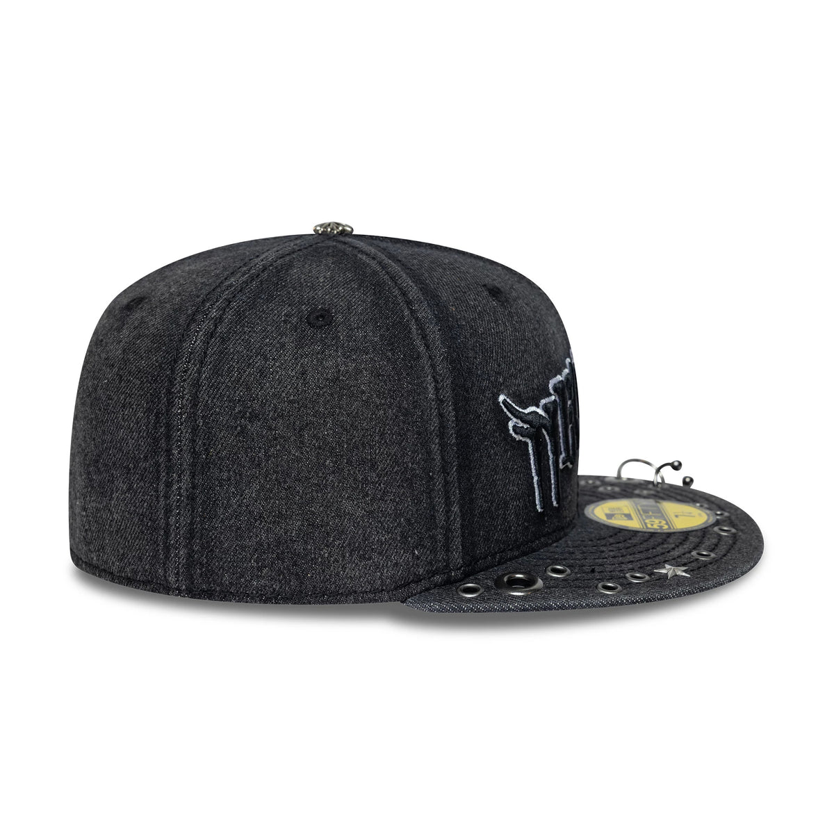 New Era Hardware Washed Black 59FIFTY Fitted Cap, three-quarter view showing a side-placed white embroidered logo, a distressed washed black fabric finish, and eyelets the black flat visor with a gold 59FIFTY size sticker.