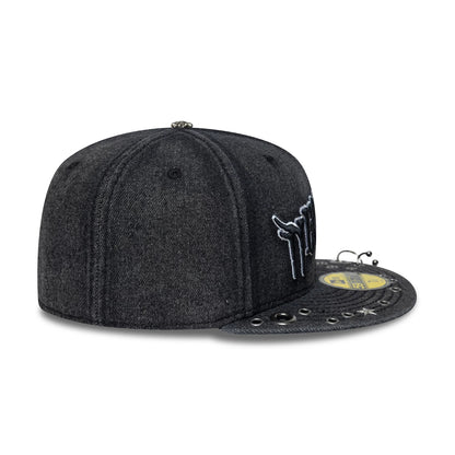 New Era Hardware Washed Black 59FIFTY Fitted Cap, three-quarter view showing a side-placed white embroidered logo, a distressed washed black fabric finish, and eyelets the black flat visor with a gold 59FIFTY size sticker.