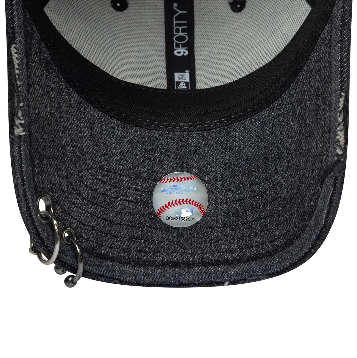 New York Yankees MLB Hardware Black New Era 9FORTY Adjustable Denim Cap, inside view with a black sweatband and grey panels, features a 9FORTY size sticker on the dark denim undervisor and silver rings on the left side of the visor.