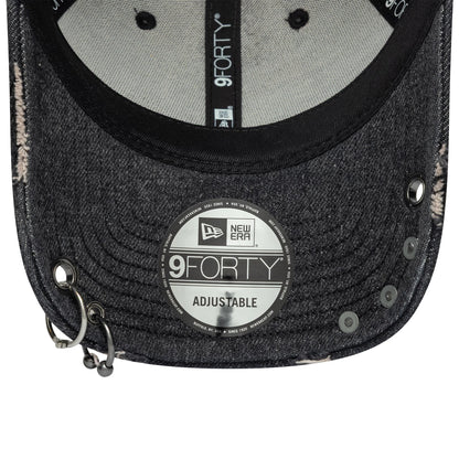 New Era Hardware Washed Black 9FORTY Adjustable Cap, inside view showing black taping with repeated 9FORTY branding, a silver 9FORTY size sticker on the washed black curved visor, and eyelets near the cap's front edge.