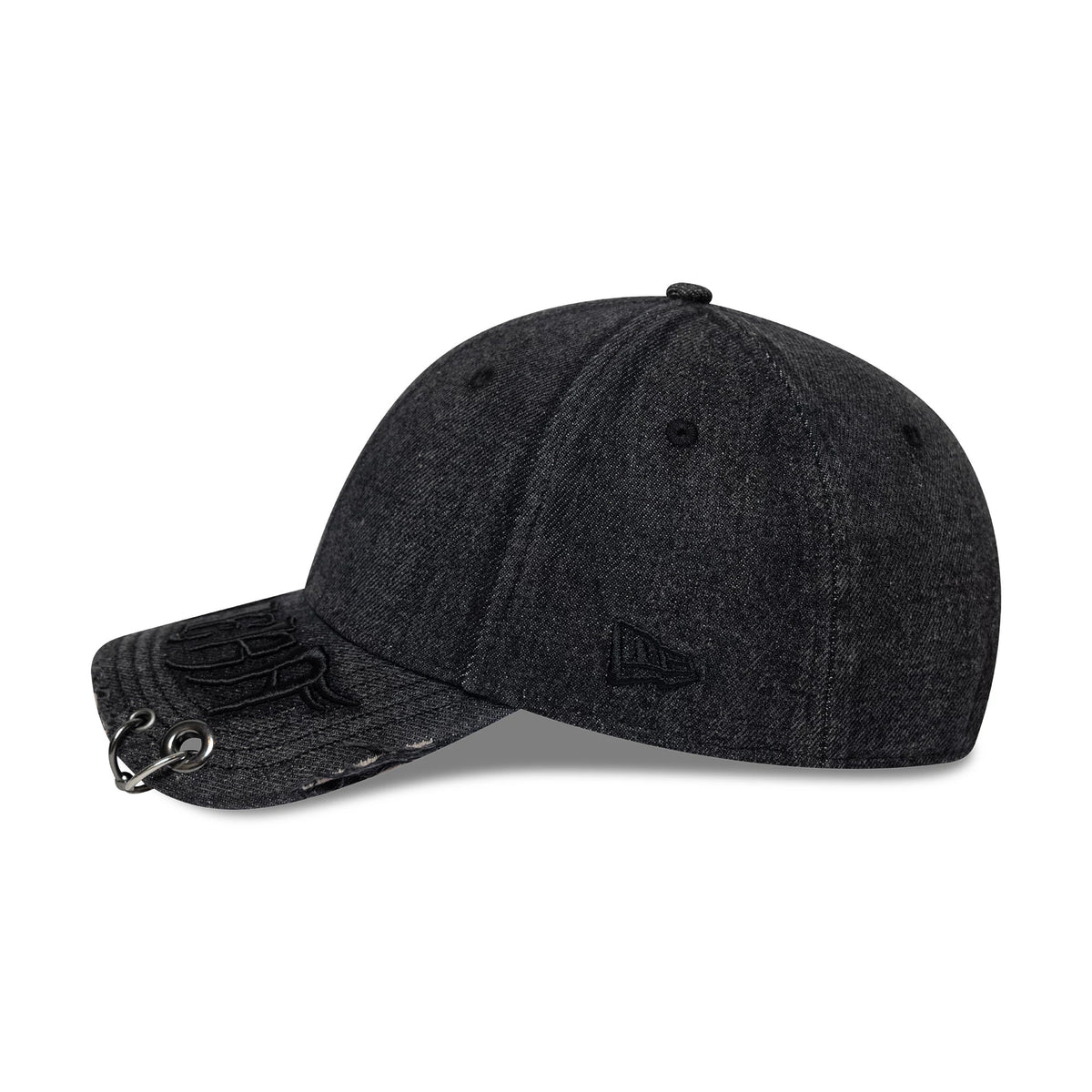 New Era Hardware Washed Black 9FORTY Adjustable Cap, side view showing the black embroidered New Era flag logo on the left side, a black embossed design on the visor with eyelets, and a softly curved visor with a washed finish.
