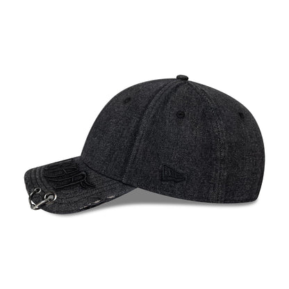 New Era Hardware Washed Black 9FORTY Adjustable Cap, side view showing the black embroidered New Era flag logo on the left side, a black embossed design on the visor with eyelets, and a softly curved visor with a washed finish.