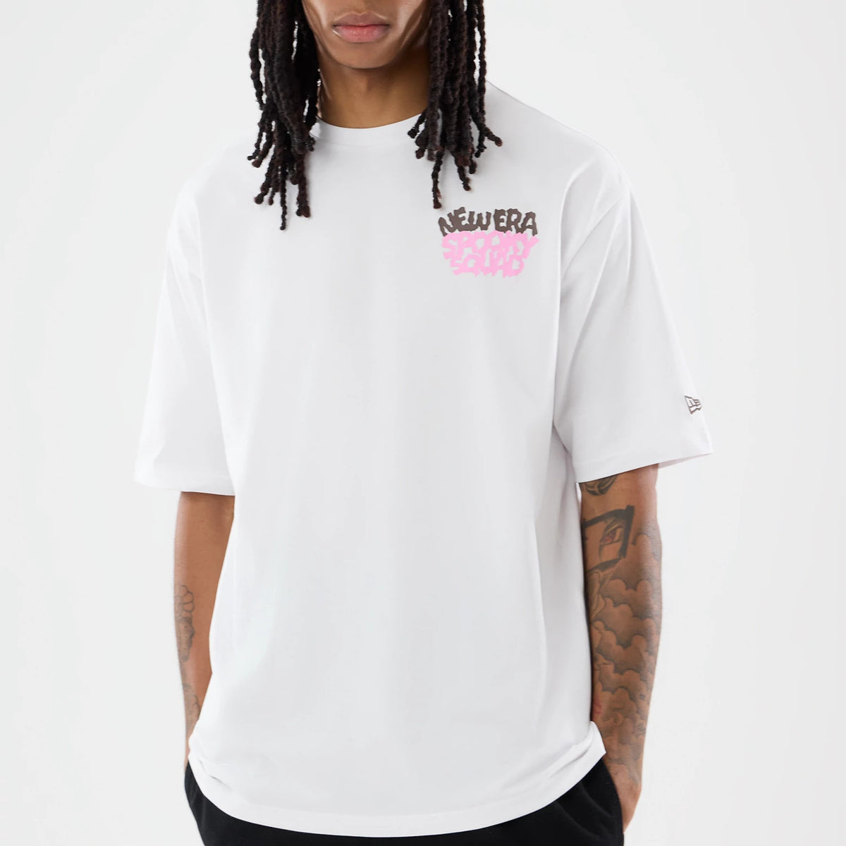 The model is wearing this New Era Spooky Graphic Oversized T-Shirt in white. 4