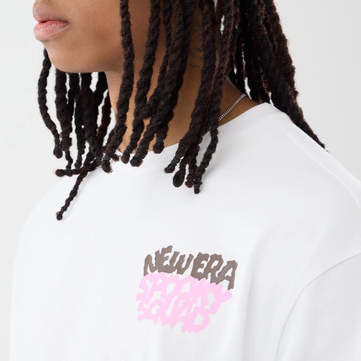 The model is wearing this New Era Spooky Graphic Oversized T-Shirt in white. 3