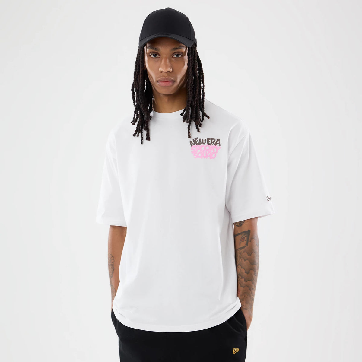 The model is wearing this New Era Spooky Graphic Oversized T-Shirt in white. 1